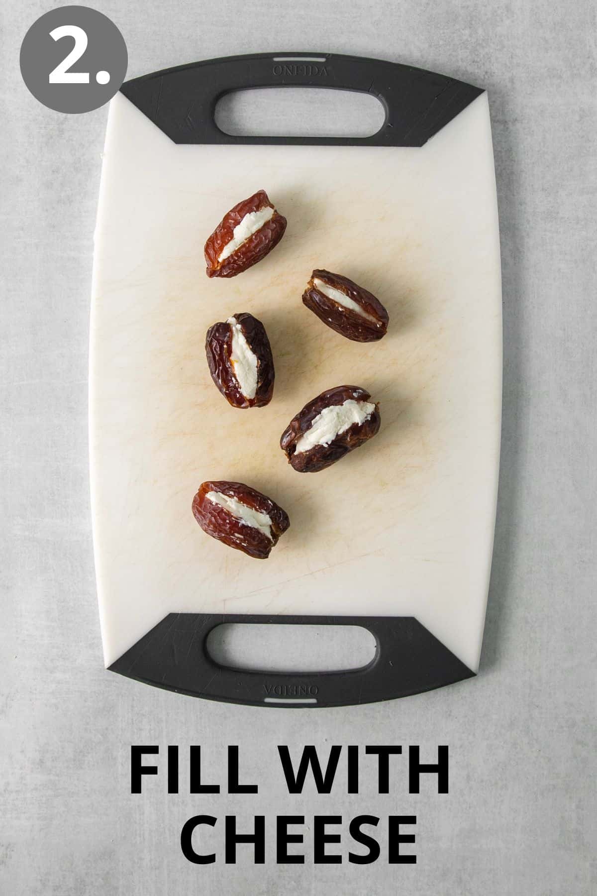 Cheese-filled dates on a cutting board