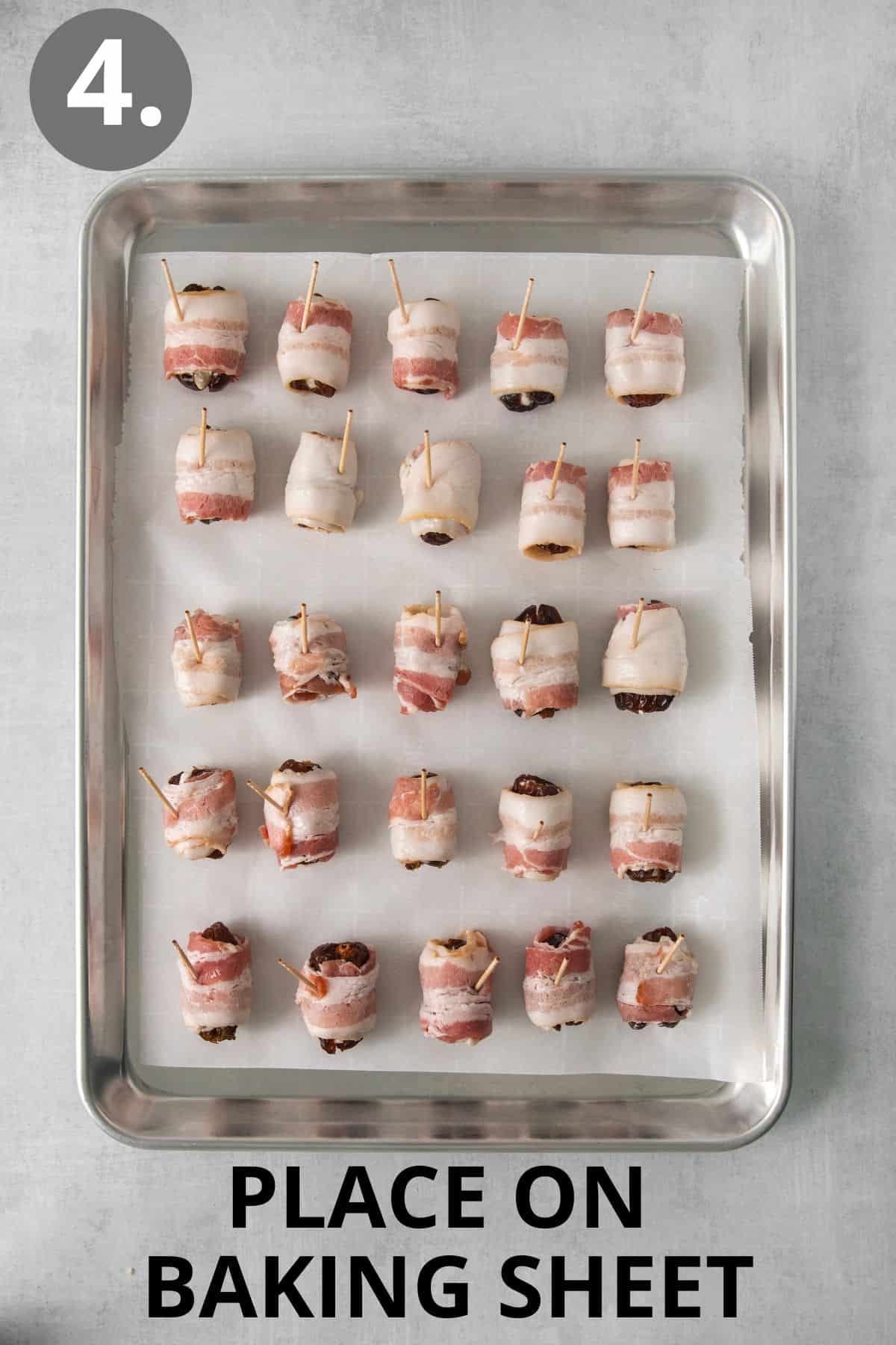 Raw bacon-wrapped dates on a baking sheet