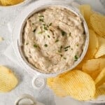 Caramelized onion dip in a bowl with chips on the side