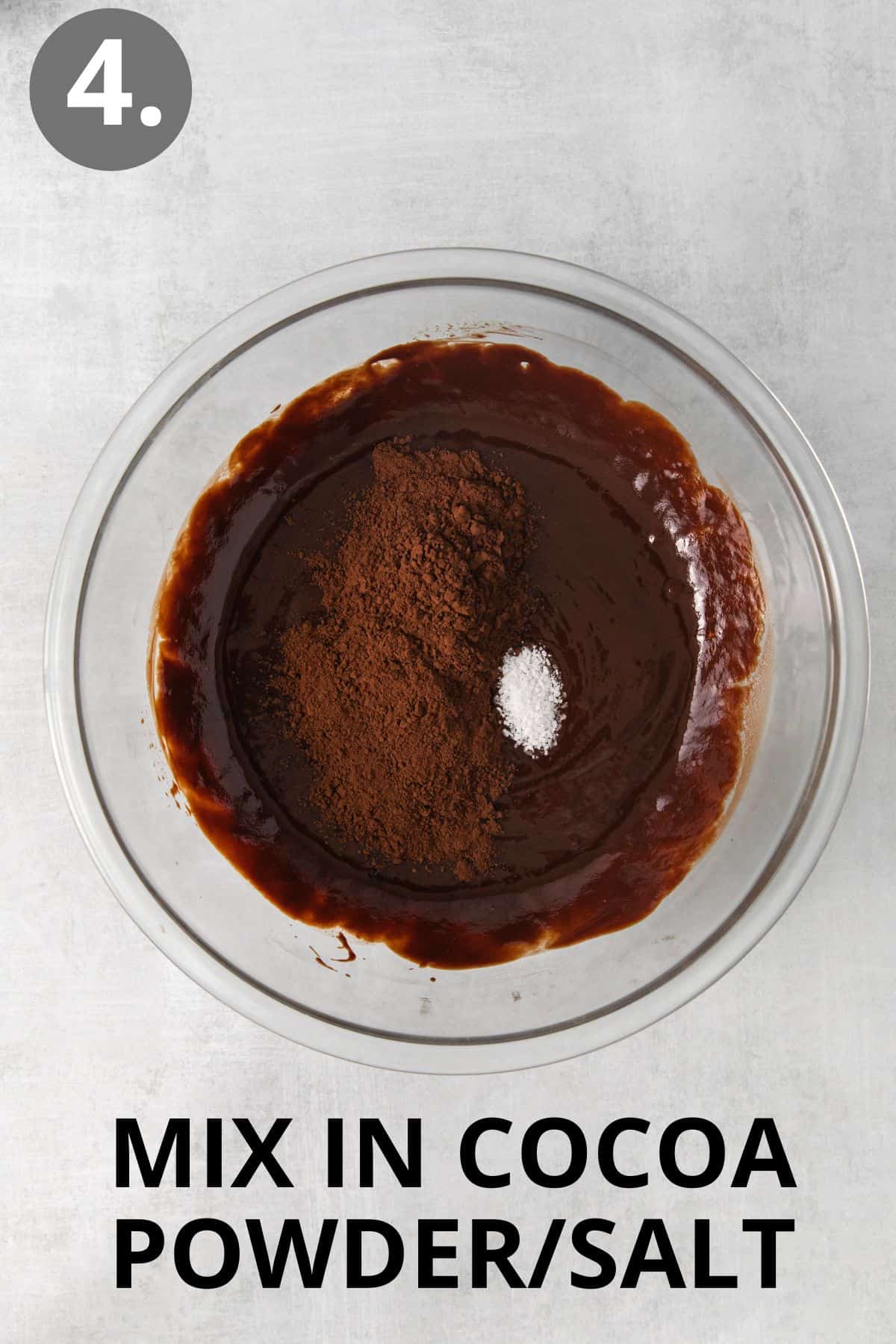 Cocoa powder and salt mixed into the batter in a glass bowl