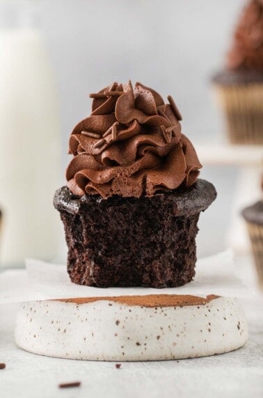 Side view of a gluten-free chocolate cupcake with a bite taken out of it