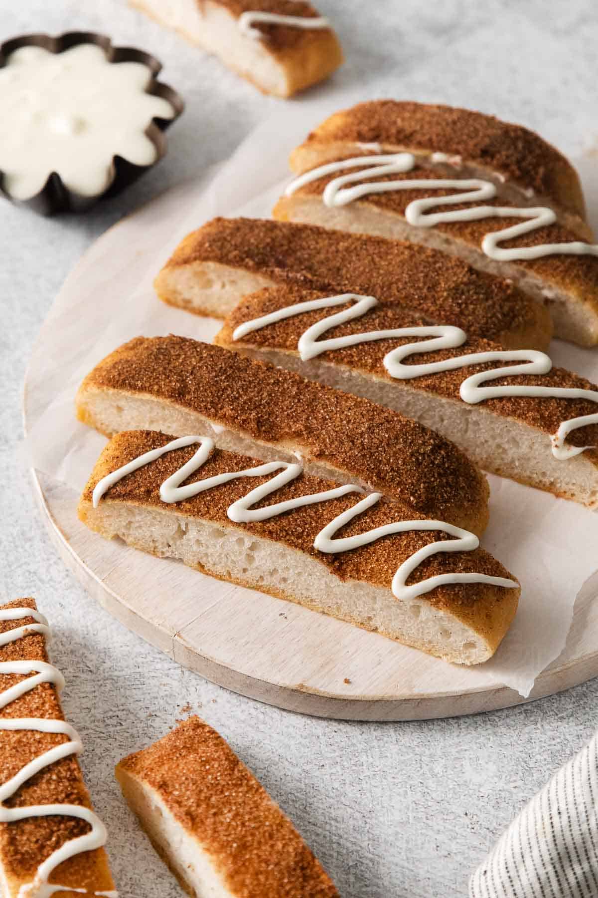 Gluten-free cinnamon breadsticks on a serving board