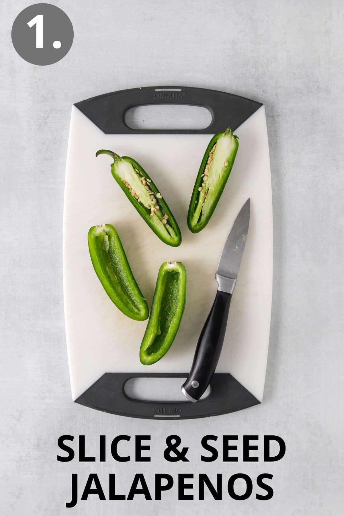 Jalapenos and a knife on a cutting board