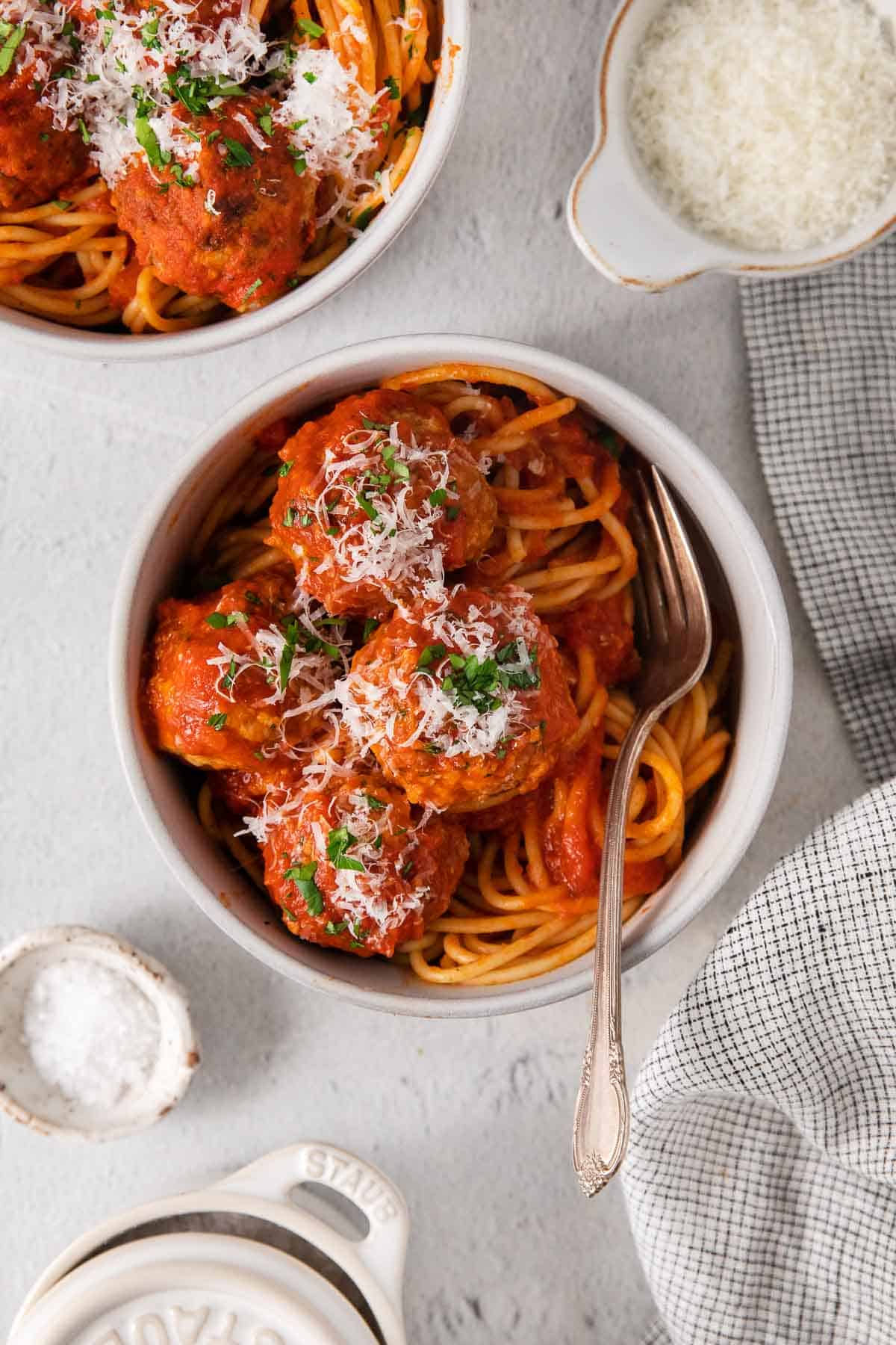 Gluten-free meatballs in a bowl with spaghetti and a fork