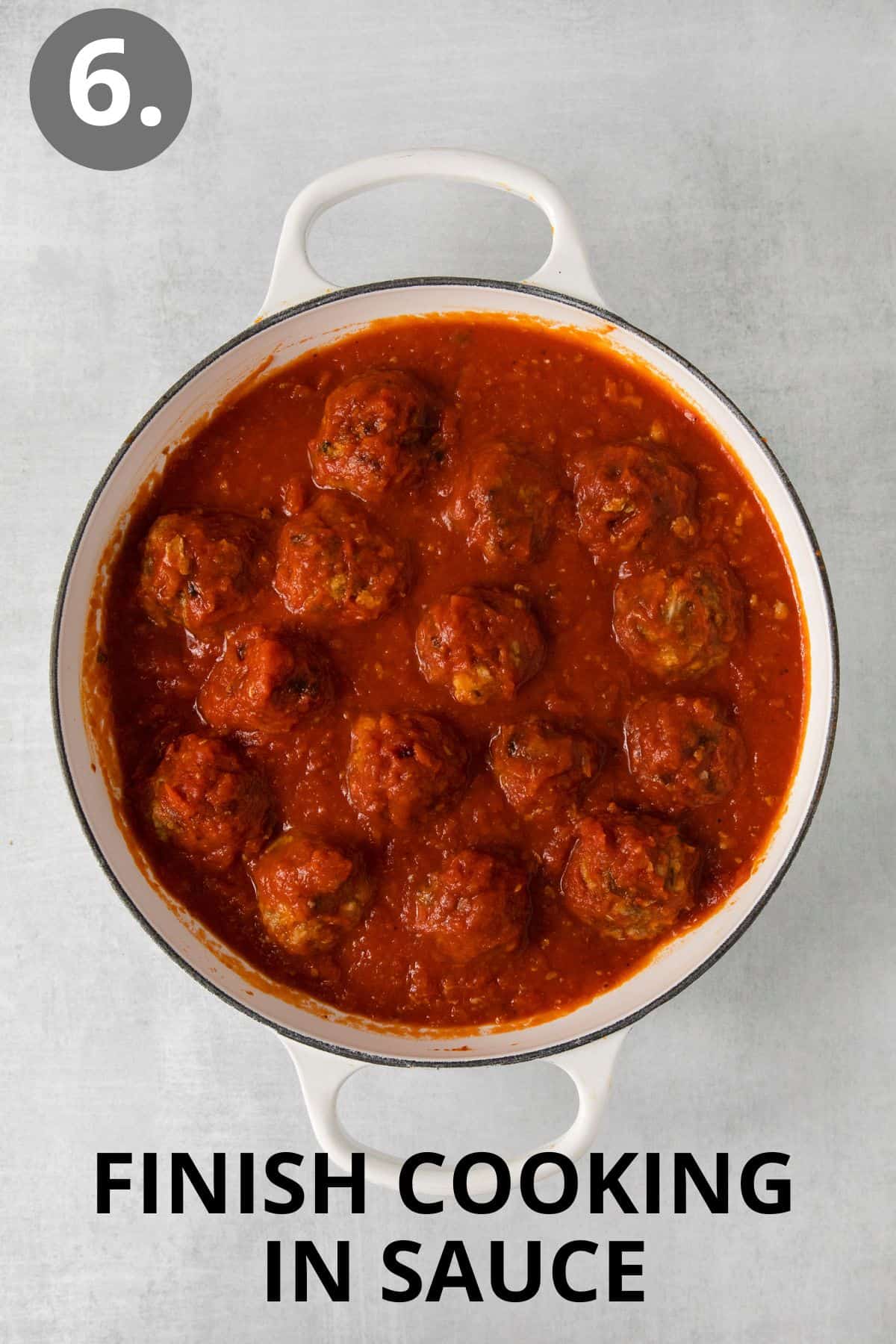 Meatballs cooking in a pot with sauce