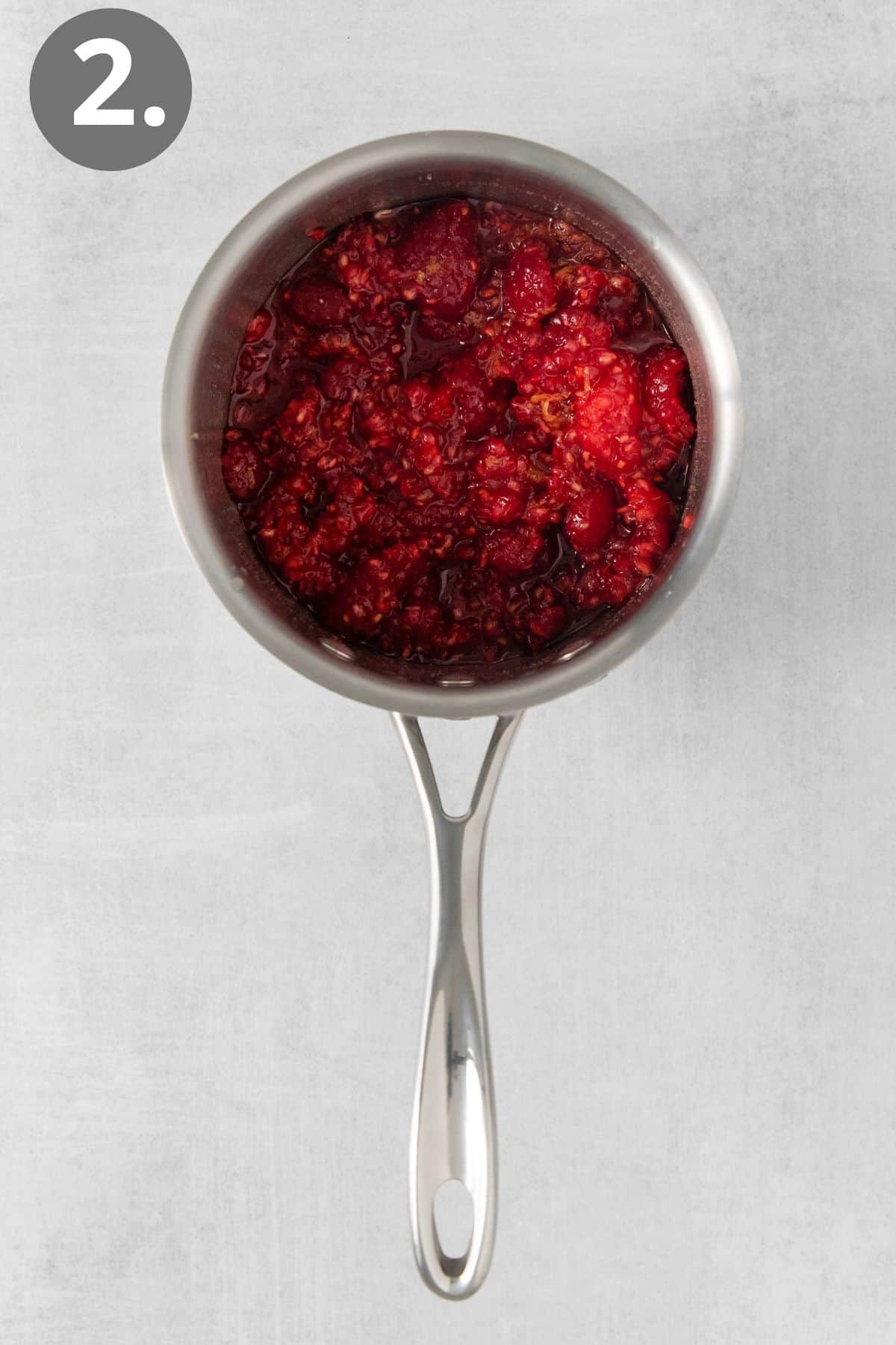 Raspberries cooking in a sauce pan