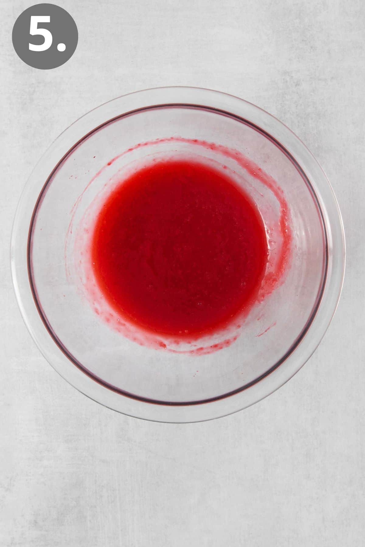 Raspberry coulis in a glass bowl