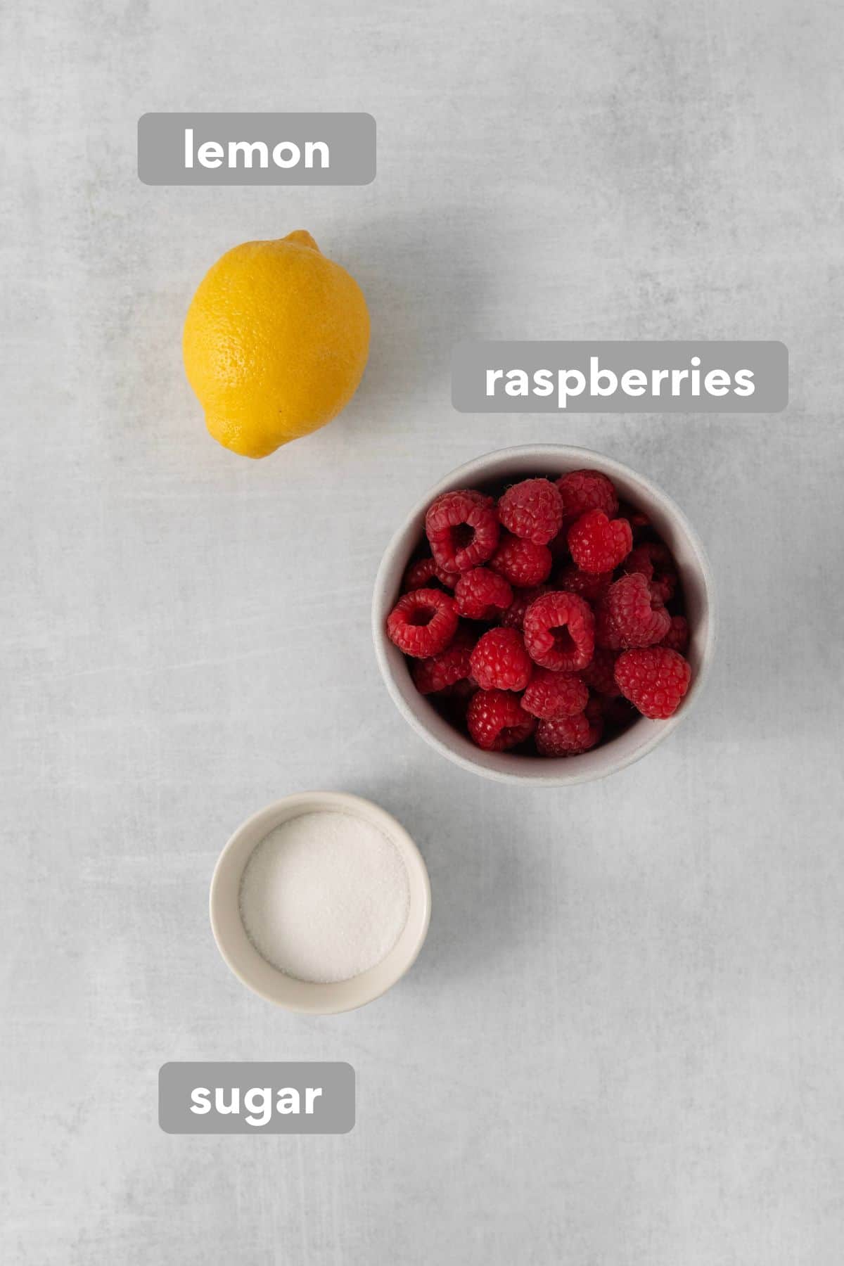 Ingredients for raspberry coulis on a countertop