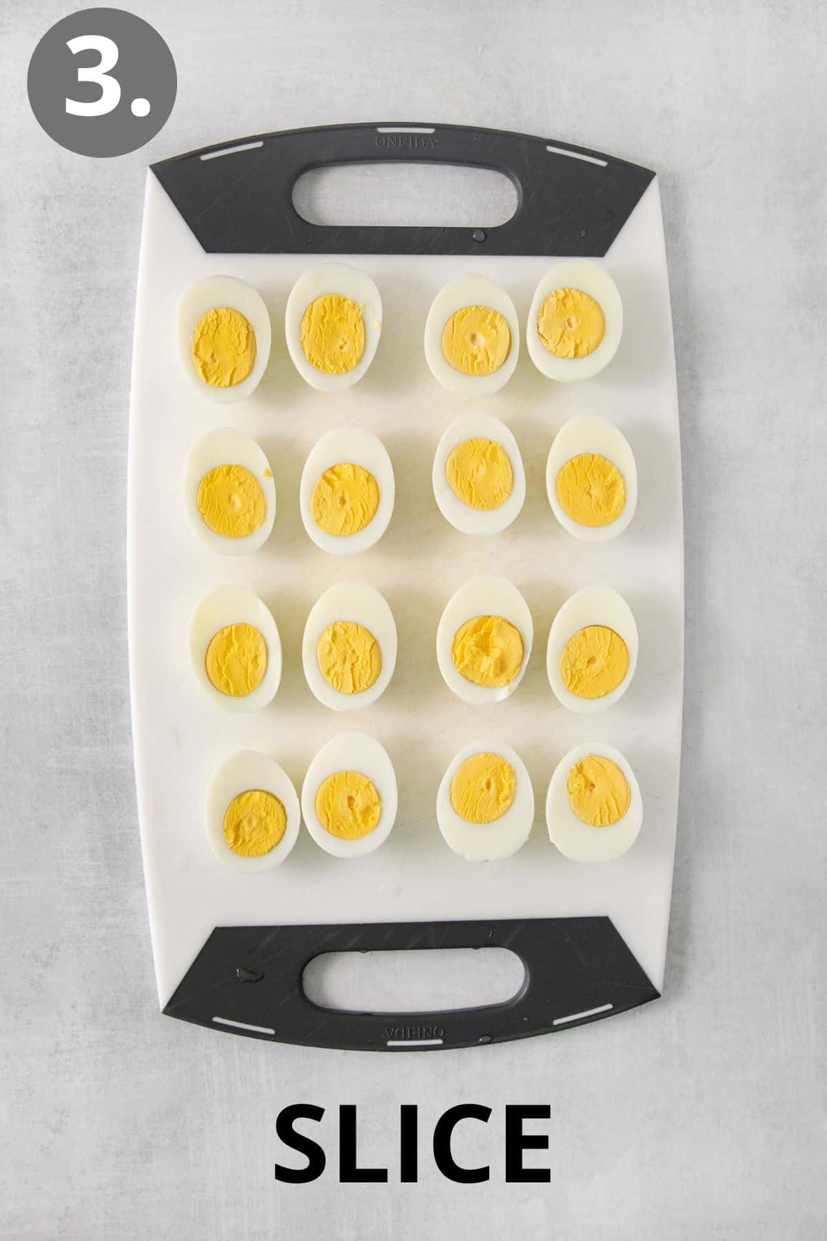 Hard-boiled eggs sliced in half on an a cutting board
