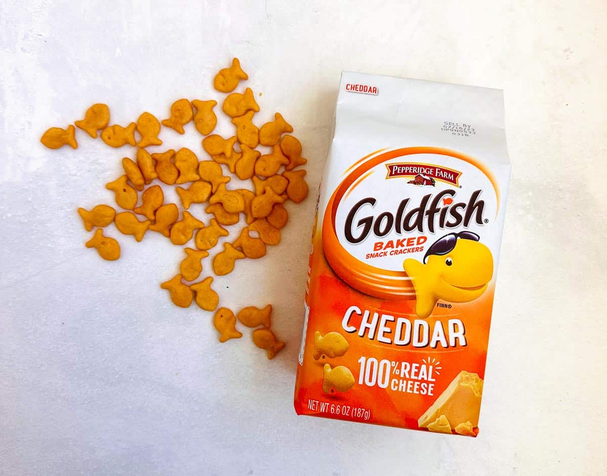 goldfish crackers next to package on white background