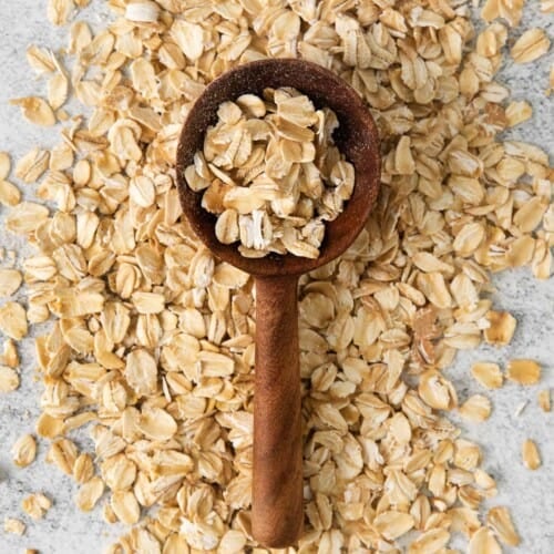 overhead shot of oats with wooden spoon