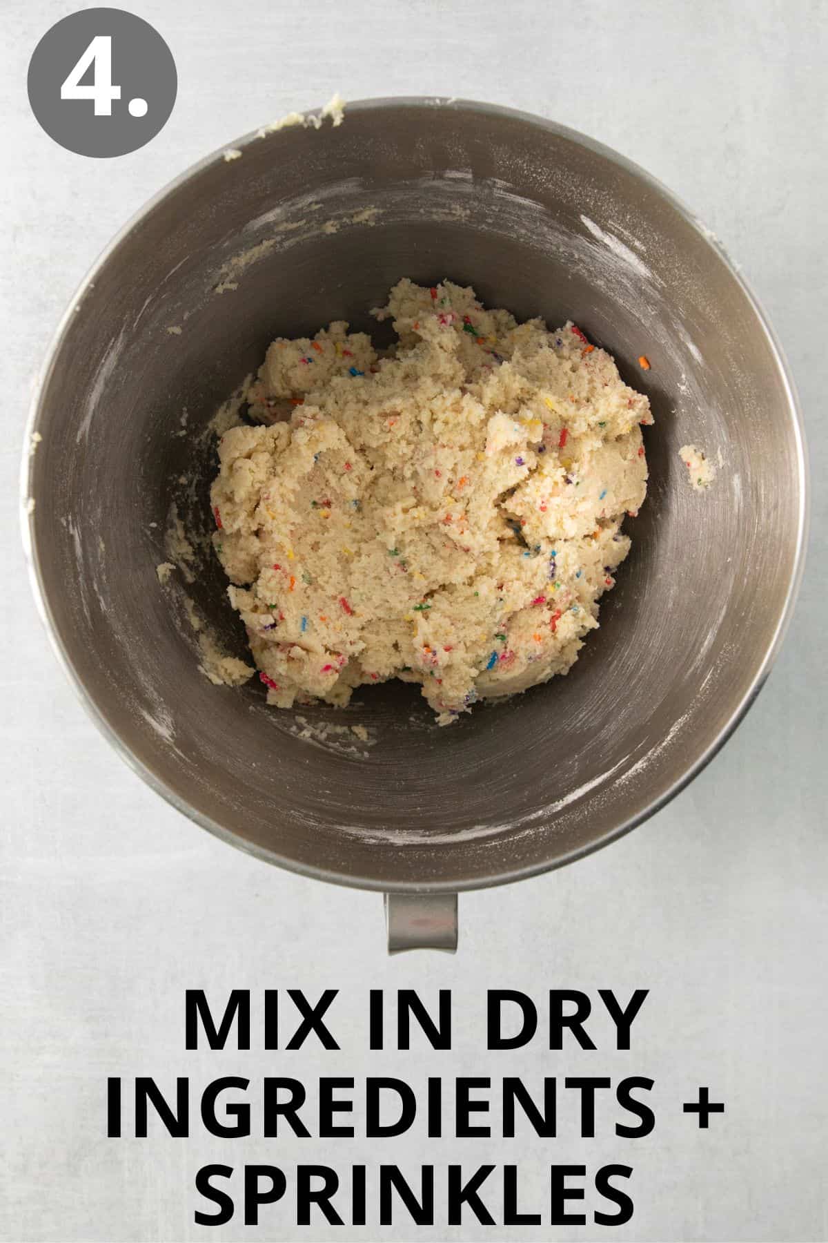 Sugar cookie dough mixed together in a stand mixer bowl