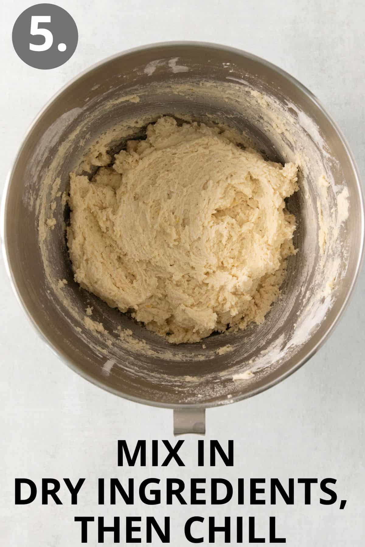 Dry ingredients mixed in a bowl with butter, sugar, and other wet ingredients