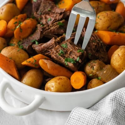 Sirloin roast with carrots and potatoes in a baking dish