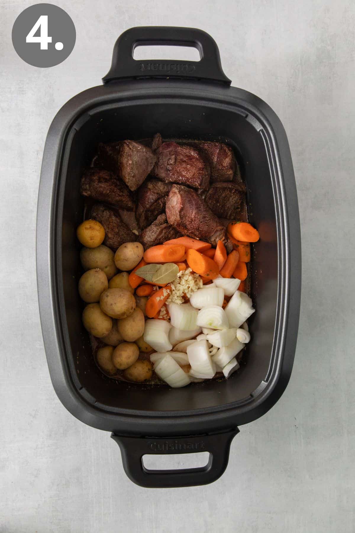 Sirloin tip roast, carrots, potatoes, and onions in a slow cooker
