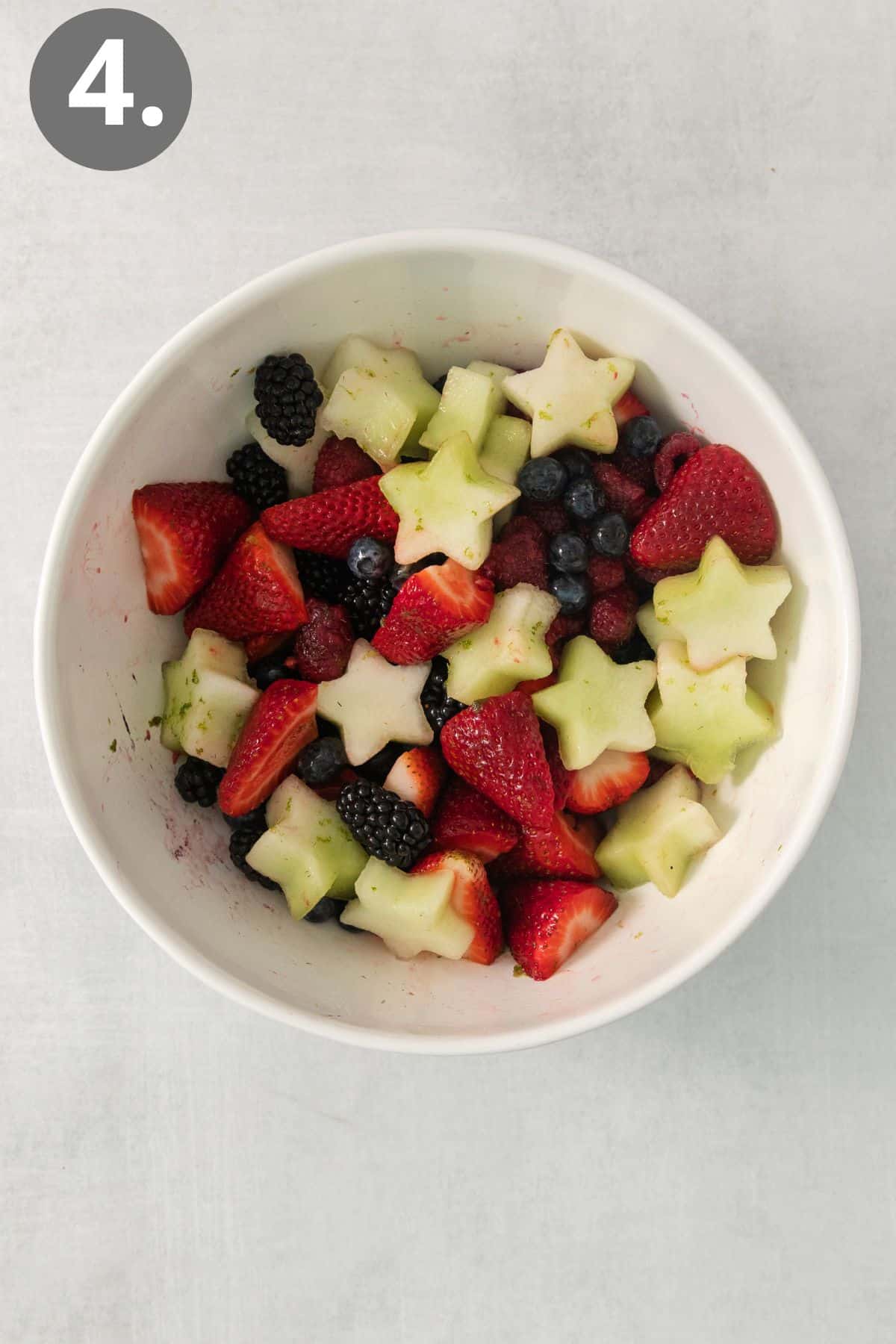Fourth of July fruit salad tossed in a bowl