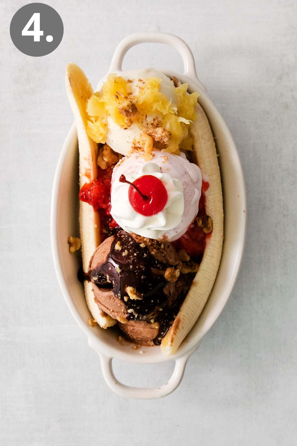 Banana split in a dish with a cherry on top