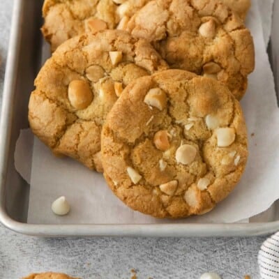 White chocolate macadamia nut cookies on a baking tray with parchment paper