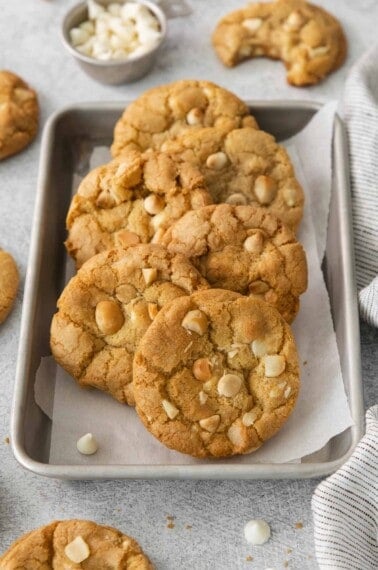 White chocolate macadamia nut cookies on a baking tray with parchment paper