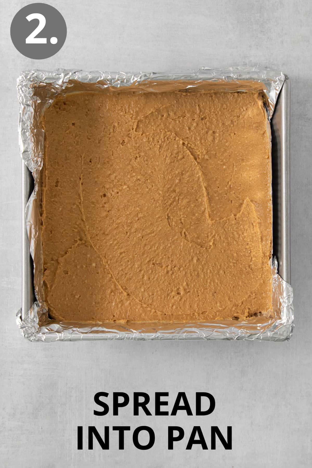 Peanut butter bar ingredients spread in a pan