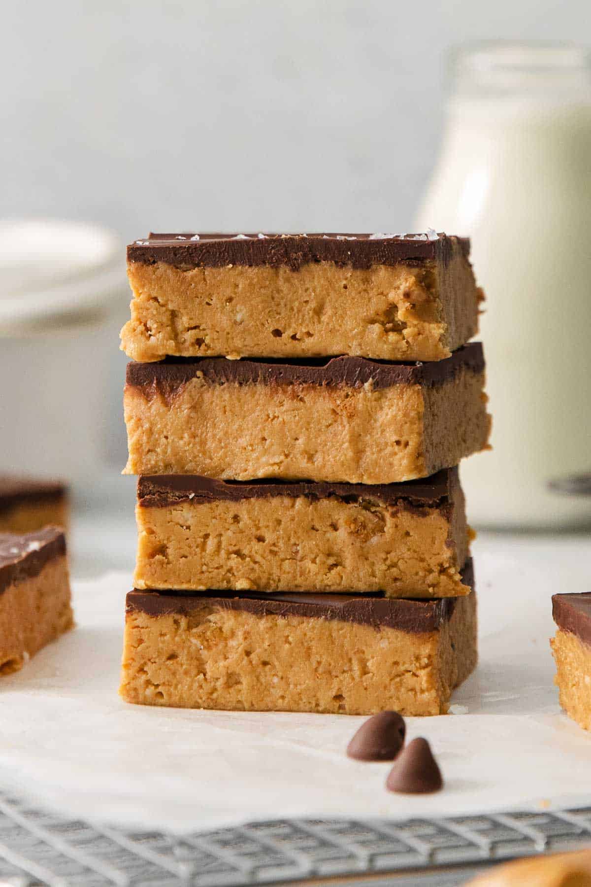 Peanut butter bars stacked on top of each other on a countertop