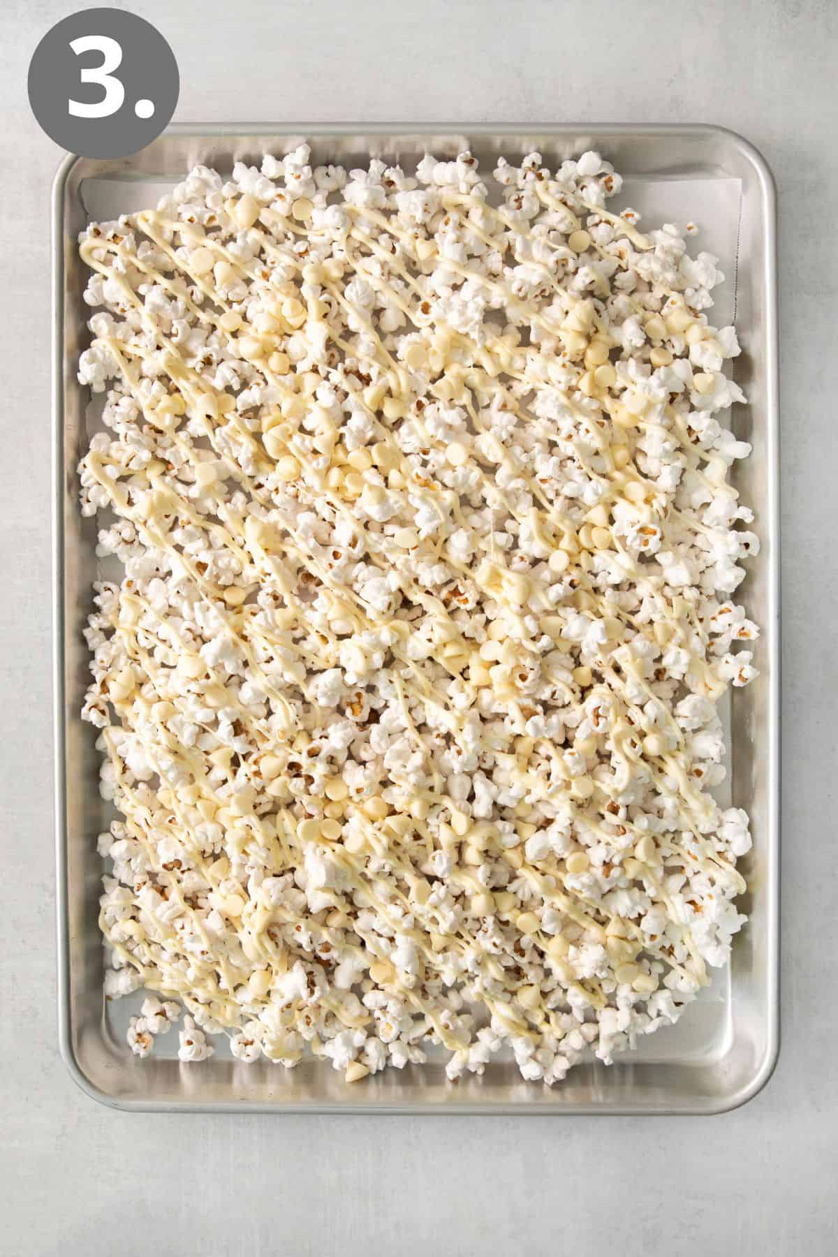 White chocolate popcorn on a baking tray