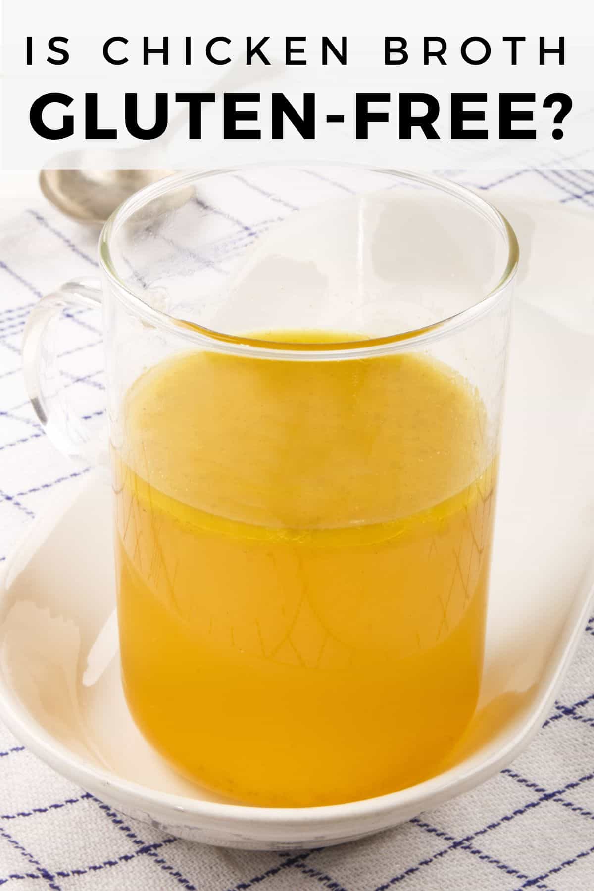 chicken stock in glass container on blue and white napkin