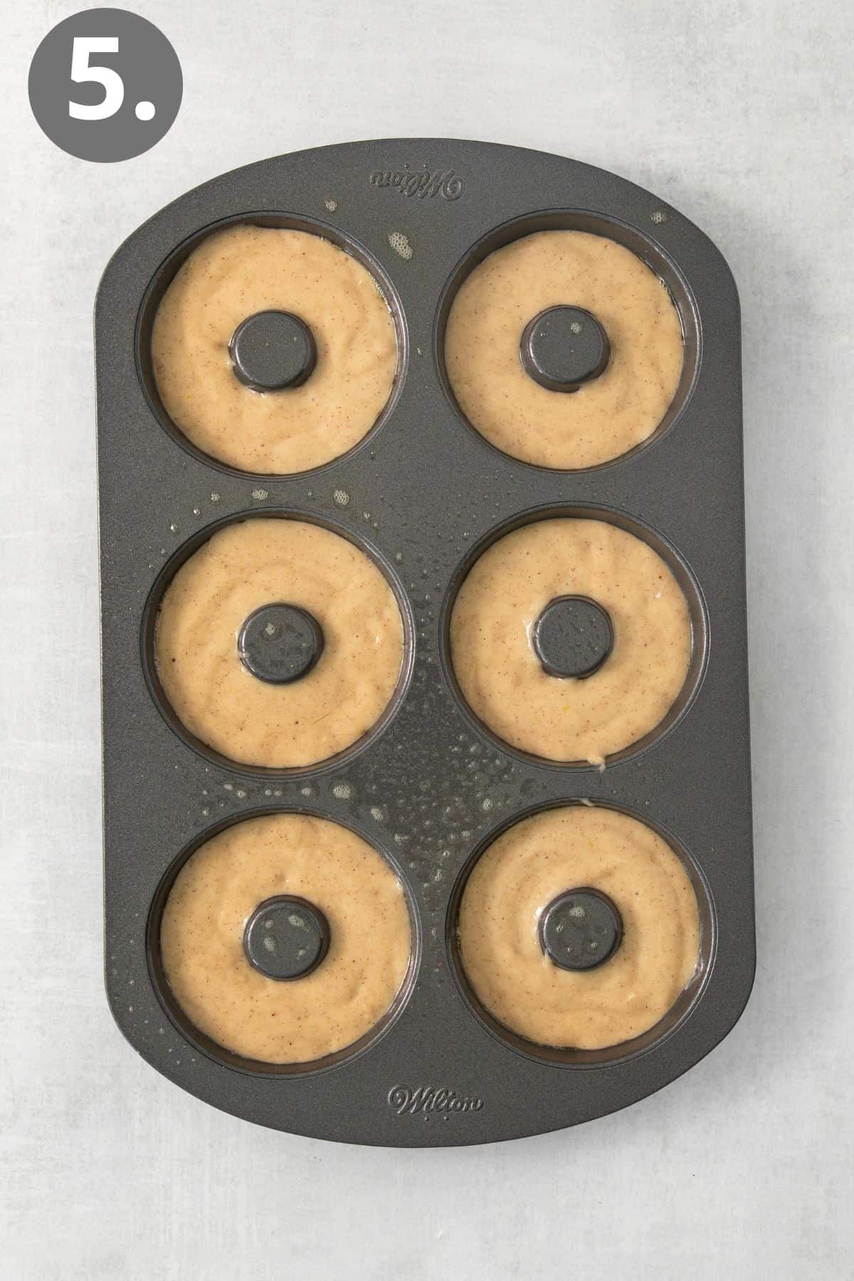 Apple cider donut batter in a donut pan