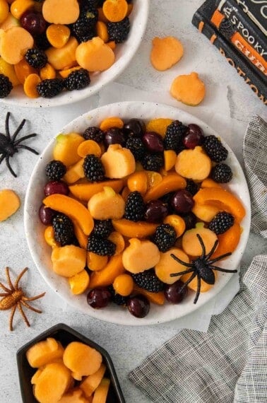 An overhead view of Halloween fruit salad in a bowl