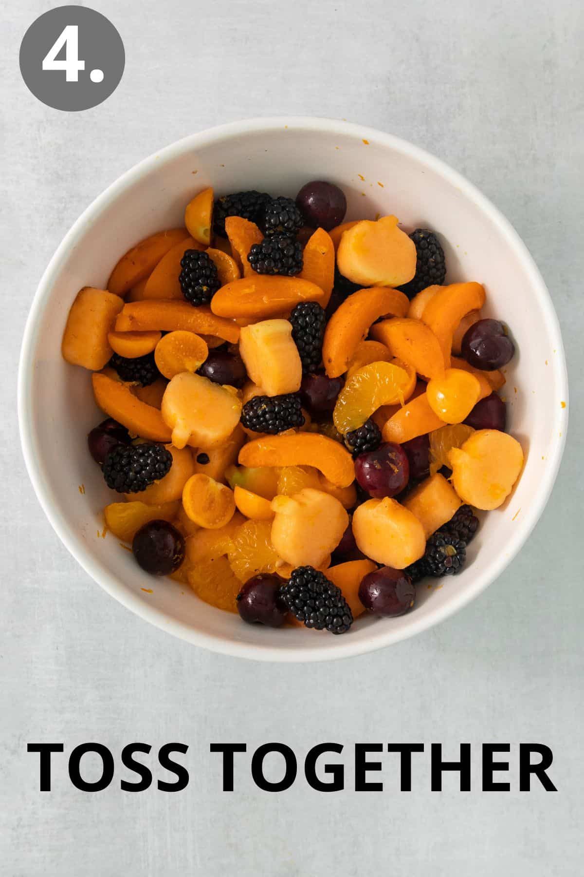 Halloween fruit salad tossed together in a bowl