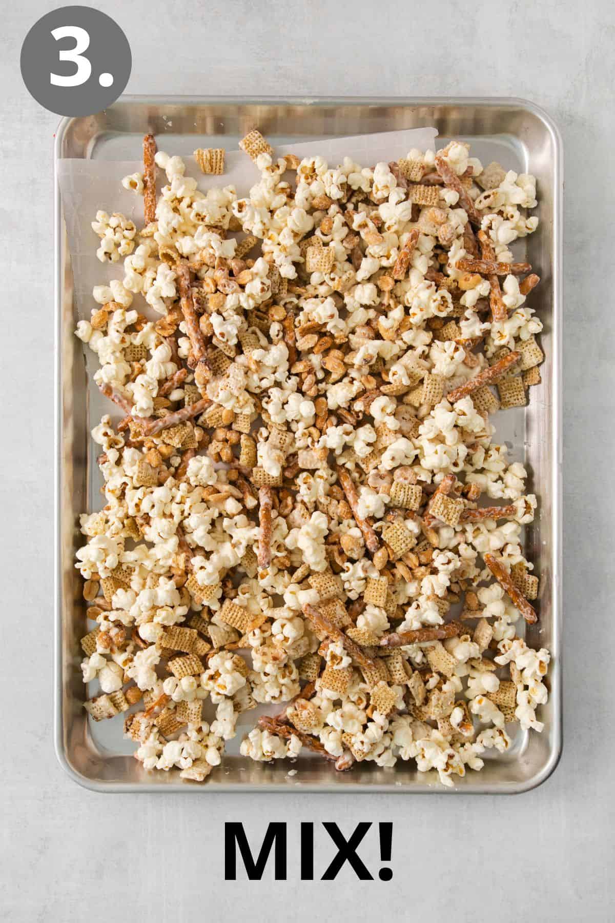 Snack mix spread on a baking sheet