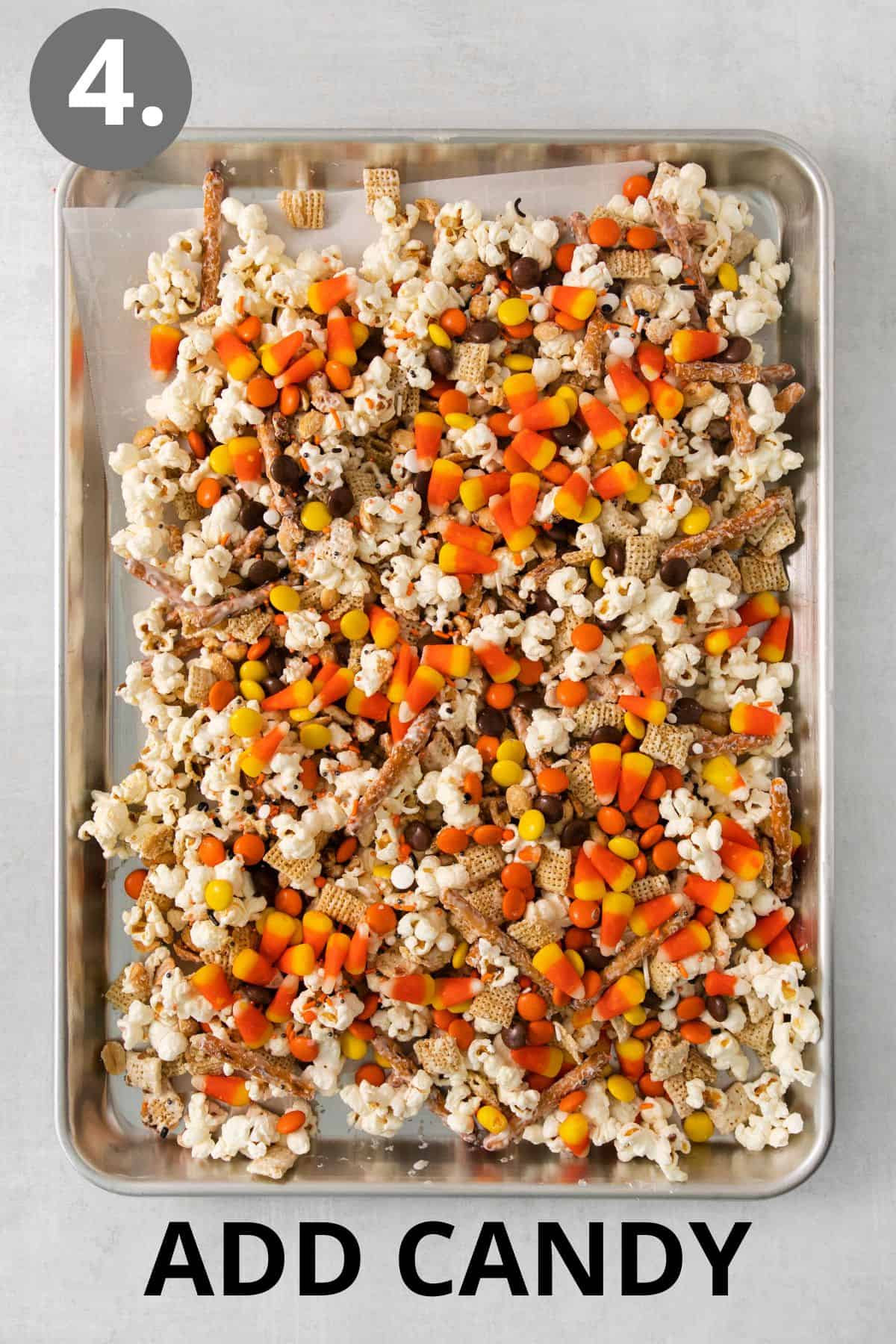 Snack mix and candy added to a baking sheet