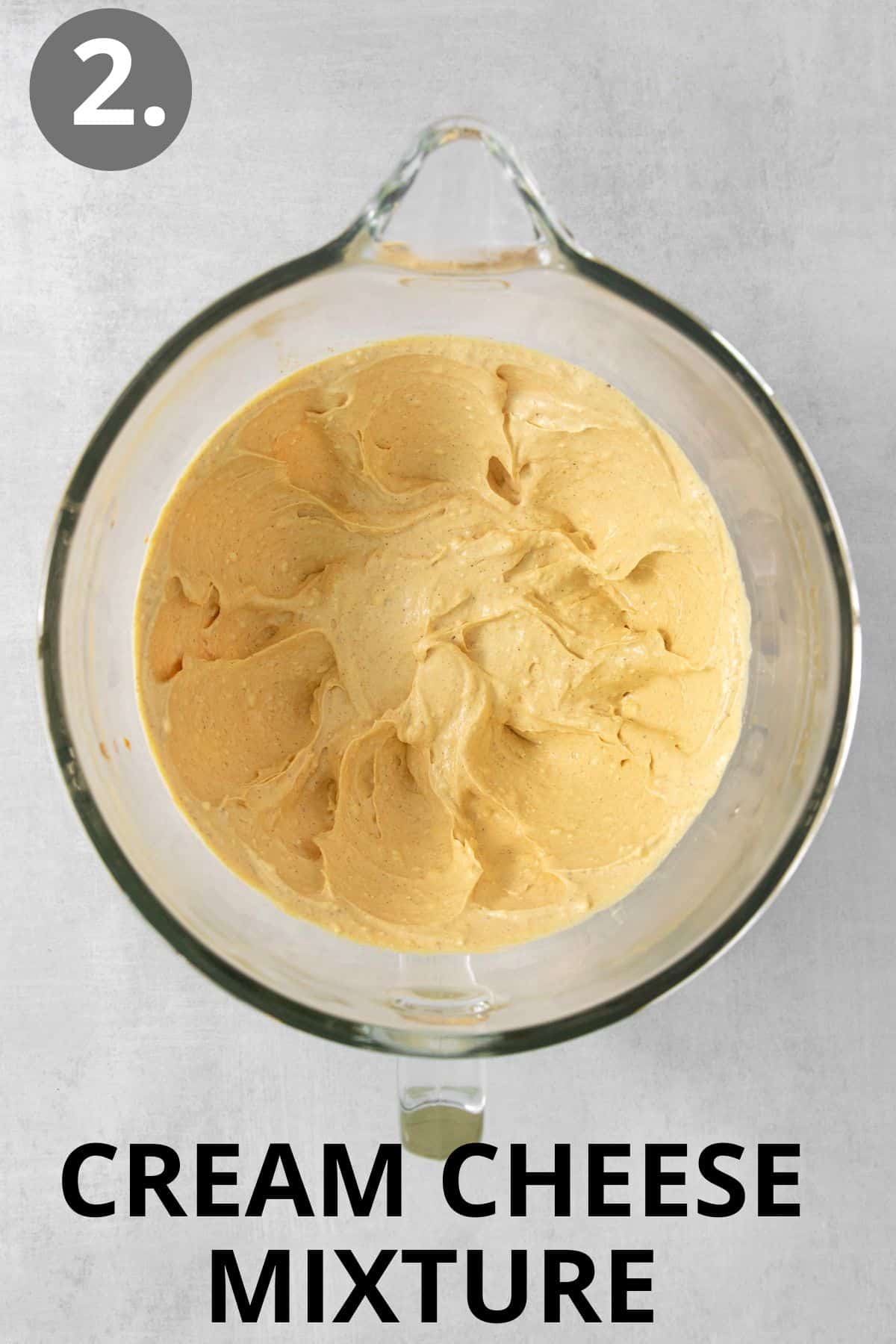Cream cheese mixture blended in a glass mixing bowl
