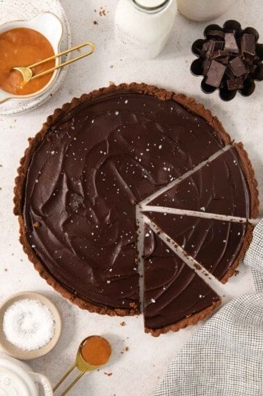 gluten-free chocolate caramel tart sliced on a countertop