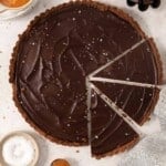 gluten-free chocolate caramel tart sliced on a countertop