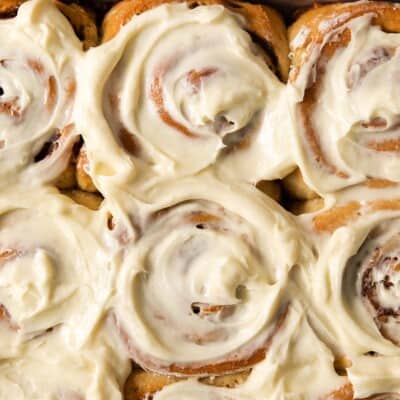 A close-up photo of frosted gluten-free cinnamon rolls