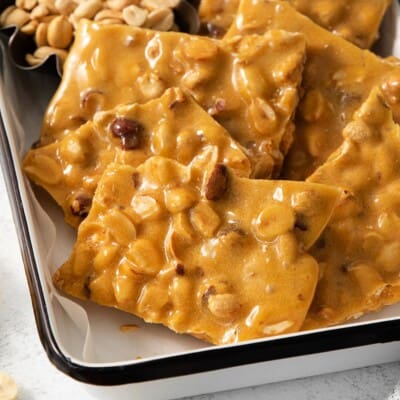 peanut brittle in a baking pan with parchment paper