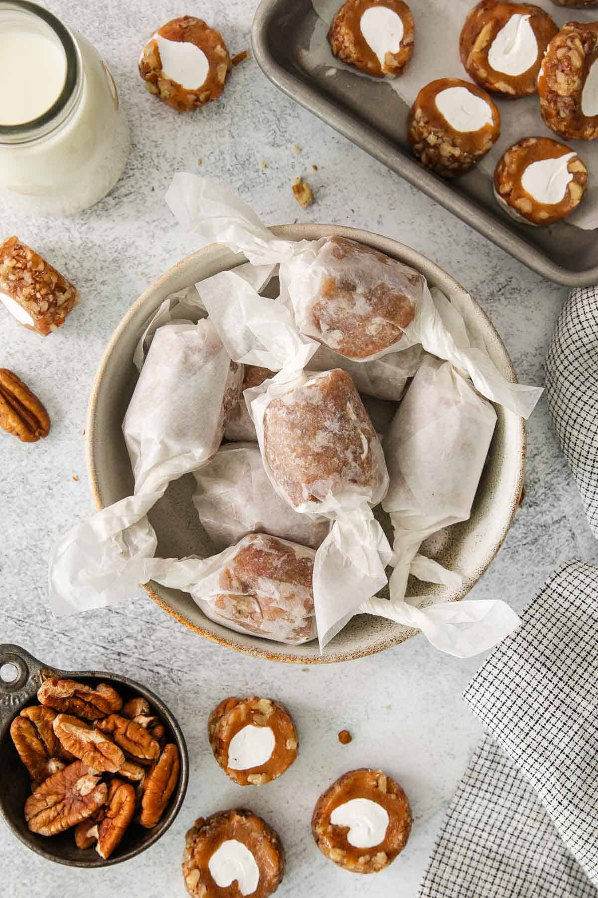 Pecan roll pieces rolled up in wax paper and placed in a bowl