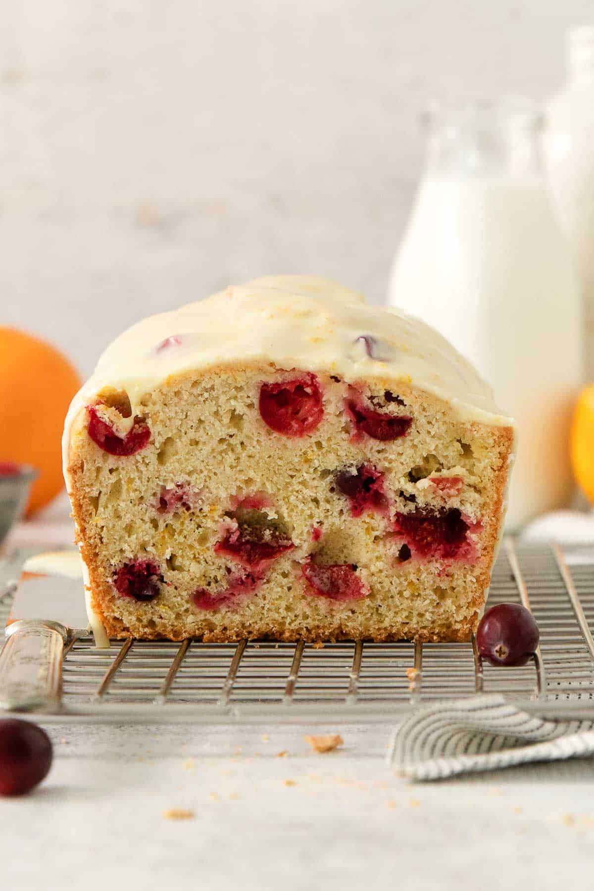 a loaf of gluten-free cranberry bread on a cooling rack