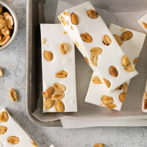 sliced nougat recipe with peanuts on baking sheet