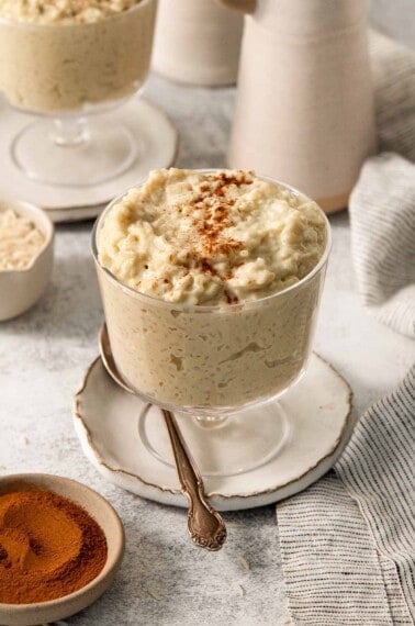 dairy-free rice pudding in a jar with a spoon resting beside it