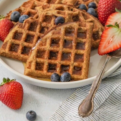 close up of buckwheat waffles on a plate with berries