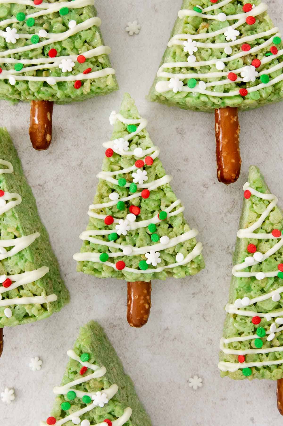 decorated Christmas tree crispy treats on a countertop.