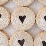 jam-filled linzer cookies with little hearts cut out from the center.