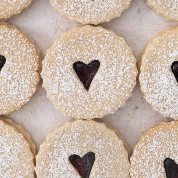 jam-filled linzer cookies with little hearts cut out from the center.