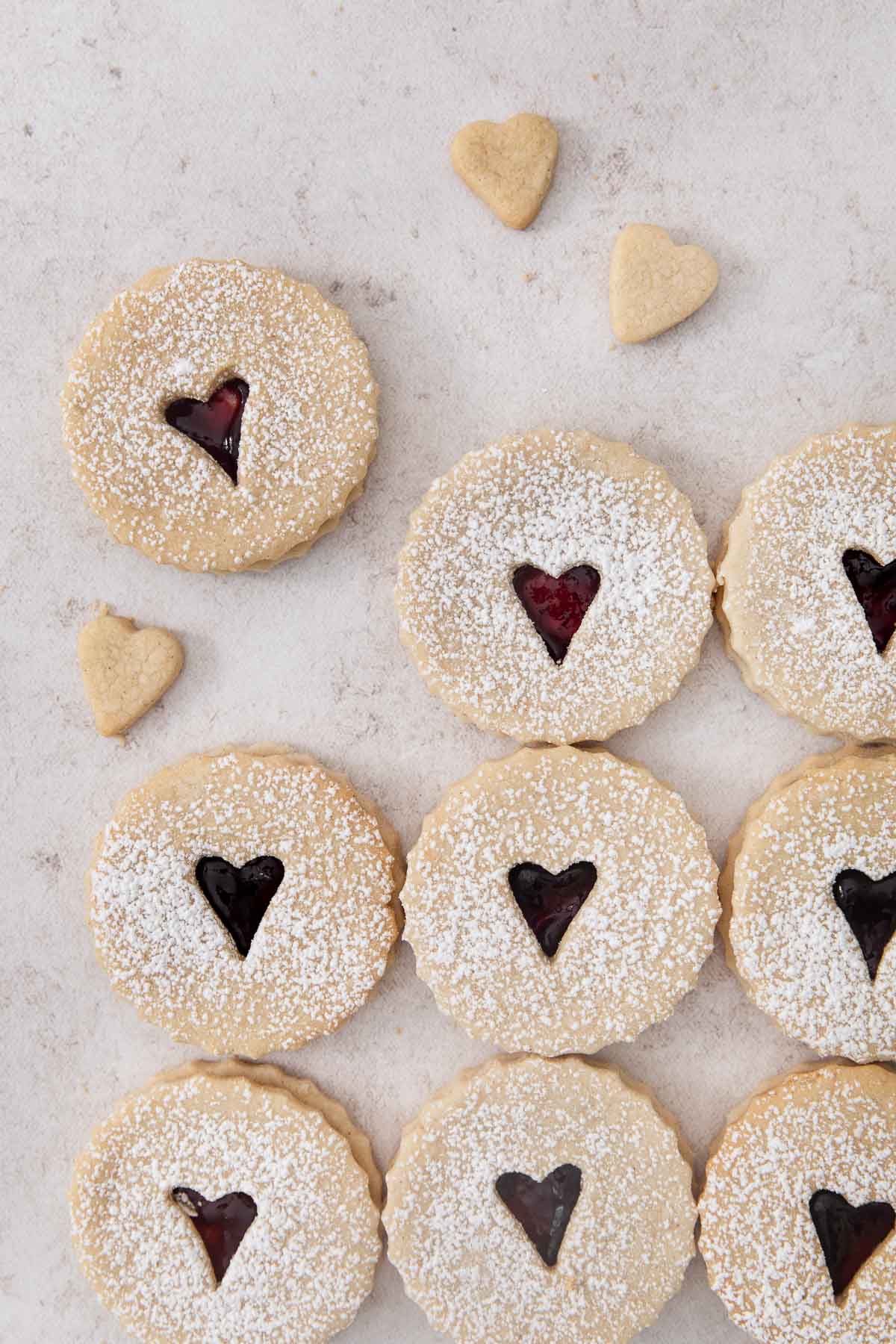 jam-filled linzer cookies on a countertop.