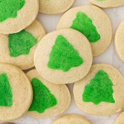 slice and bake cookies with green christmas tress on a countertop.