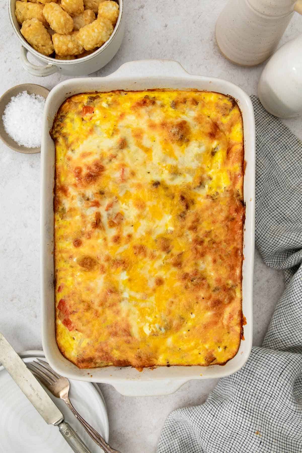 a full tater tot breakfast casserole in the baking dish.