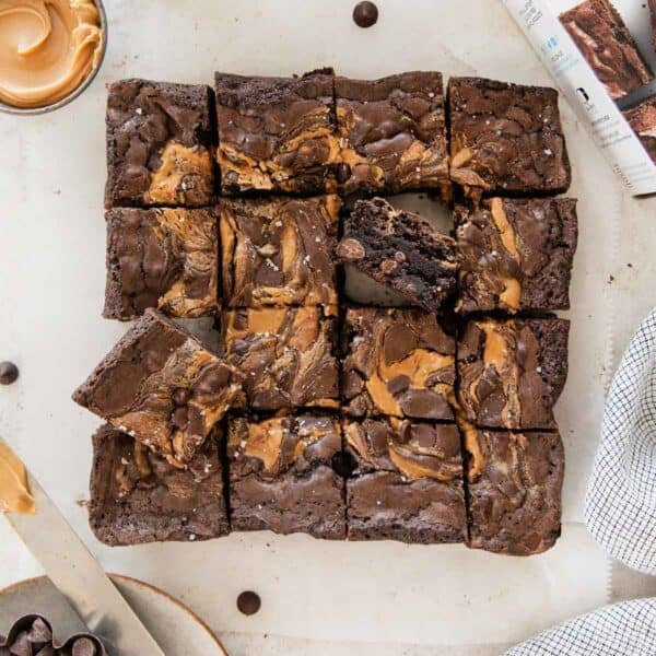 Gluten-free peanut butter brownies sliced on a piece of parchment.