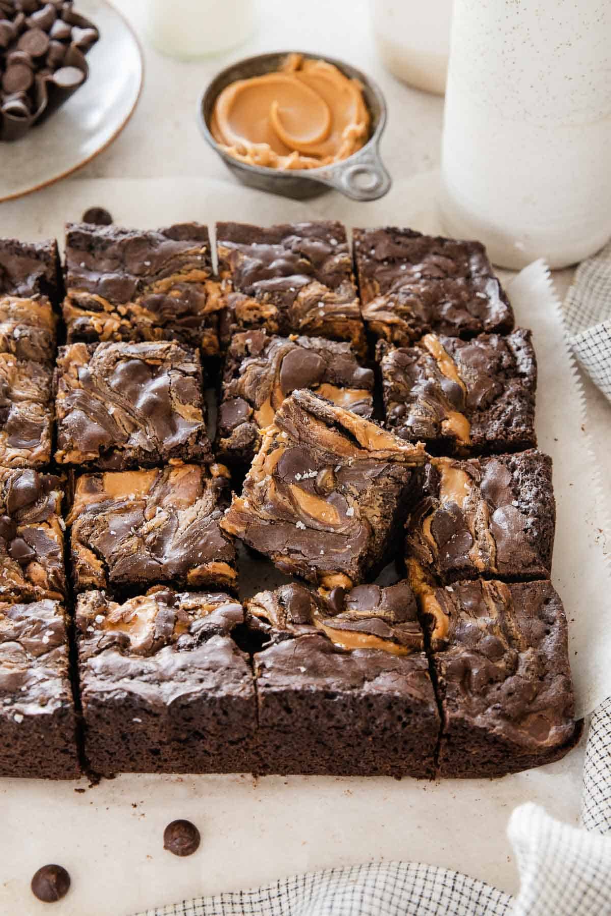 Gluten-free peanut butter brownies sliced and laying on a piece of parchment paper.
